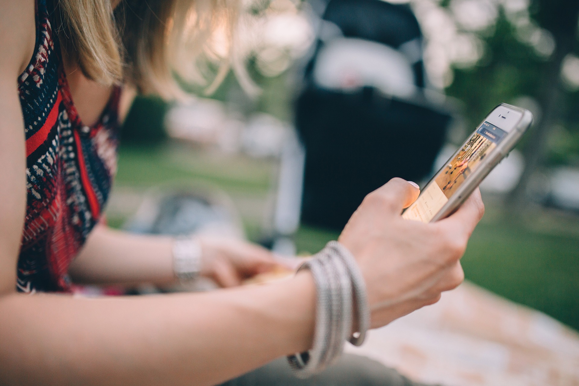 Woman using smartphone outside.